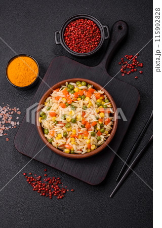 Delicious boiled rice with vegetables corn, carrots, peas with salt Delicious boiled rice with vegetables corn, carrots, peas with salt 115992828