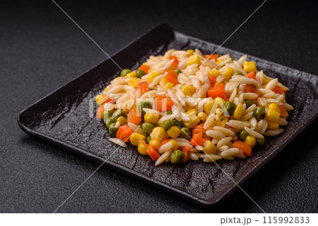 Delicious boiled rice with vegetables corn, carrots, peas with salt Delicious boiled rice with vegetables corn, carrots, peas with salt 115992833