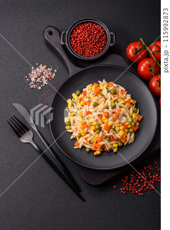 Delicious boiled rice with vegetables corn, carrots, peas with salt Delicious boiled rice with vegetables corn, carrots, peas with salt 115992873