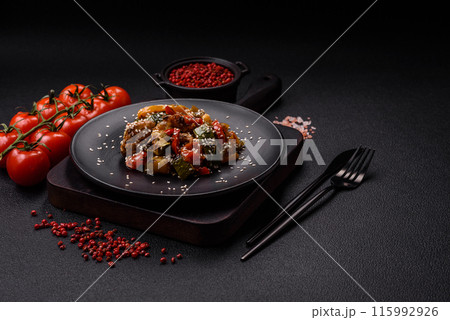 Spicy Asian dish with sliced meat fillet, hot pepper, carrots and sesame seeds Spicy Asian dish with sliced meat fillet, hot pepper, carrots and sesame seeds 115992926