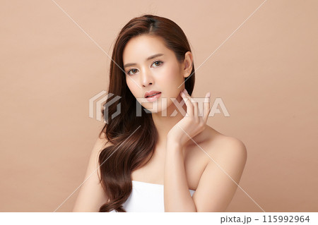 Beautiful young asian woman with clean fresh skin on beige background, Face care, Facial treatment, Cosmetology, beauty and spa, Asian women portrait. Beautiful young asian woman with clean fresh skin on beige background, Face care, Facial treatment, Cosmetology, beauty and spa, Asian women portrait. 115992964