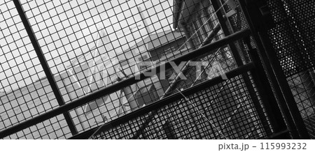 Satellite dish in Ludwigsburg photographed trough a wire net. 115993232