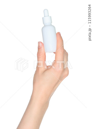Woman hand holds a white cosmetic bottle, isolated on white background close-up, template 115993264