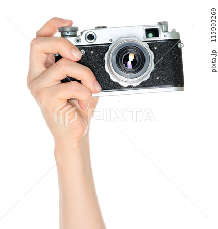 Women hand holds a retro photo camera, isolated on white background, front view, retro things 115993269