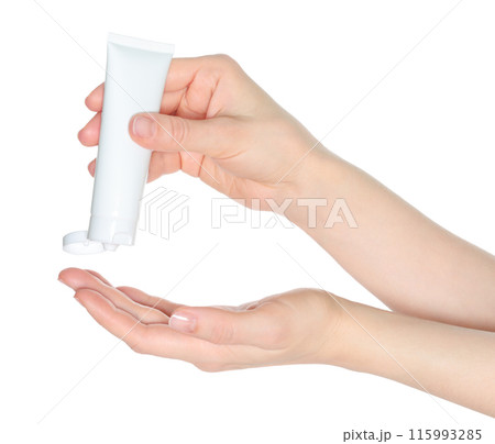 Woman hands squeezing a white cosmetic cream tube, on white background close-up, template 115993285