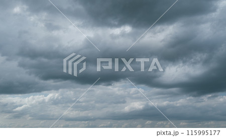 Rain clouds moving. Movement of air masses. White soft clouds quickly turning into dark grey. Timelapse. 115995177