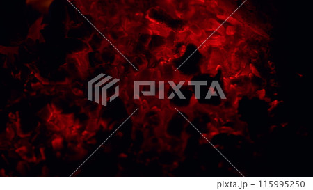 Red hot coals. Red burning ash in fireplace in black background. Close up. Red hot coals. Red burning ash in fireplace in black background. Close up. 115995250