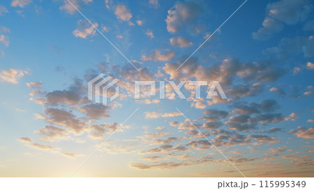 Fiery sunset clouds sky. Clear very nice soft deep blue sky with orange and peach rolling clouds. Time lapse. 115995349