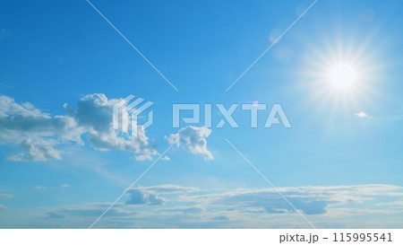 Beautiful scenic blue sky with rays of sun shining through clouds. Sun rays. Time lapse. 115995541
