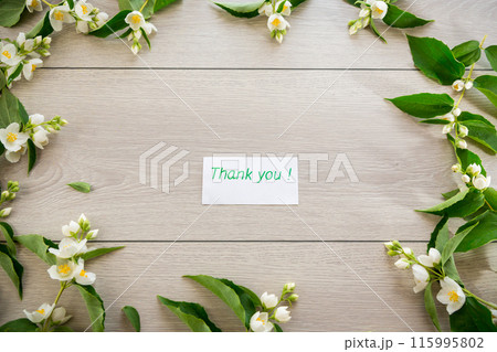 wooden light background with white jasmine flowers wooden light background with white jasmine flowers 115995802