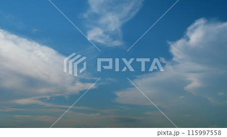 Cirrostratus clouds flying slowly on beautiful blue sky horizon background. Timelapse. 115997558