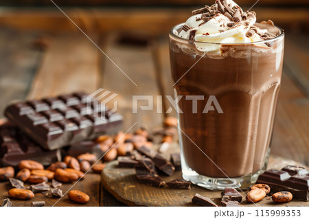 Chocolate milkshake with whipped cream on wooden board dessert concept 115999353