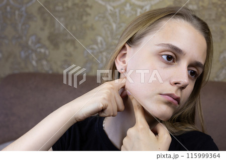 Girl massages her face to smooth out wrinkles and improve skin health at home, special facial skin care procedure 115999364