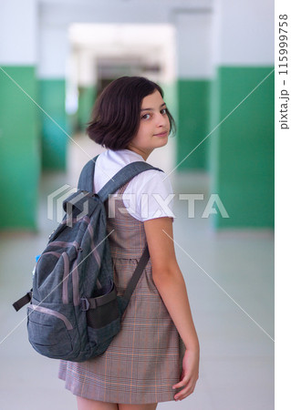 Beautiful girl in a school corridor posing for the camera 115999758