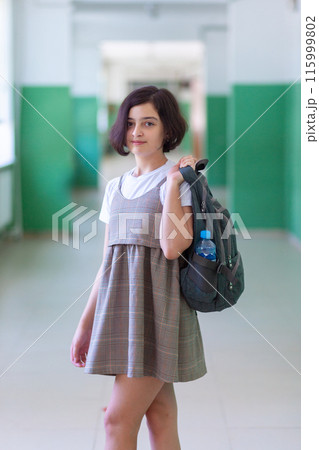 Beautiful girl in a school corridor posing for the camera Beautiful girl in a school corridor posing for the camera 115999802
