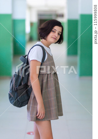 Beautiful girl in a school corridor posing for the camera 115999808