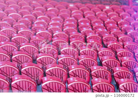 A row of red chairs are arranged in a stadium 116000172