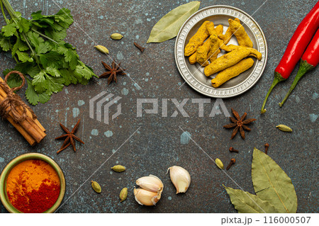 Aromatic Indian spices creating a frame on a dark textured background Aromatic Indian spices creating a frame on a dark textured background 116000507