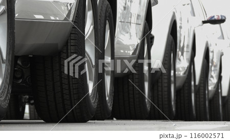 Wheels of convoy of the same cars on the asphalt Wheels of convoy of the same cars on the asphalt 116002571