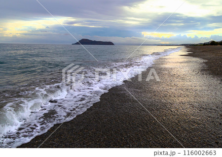 Beach on a cloudy morning. Sea wave on the coast of Greece.  116002663