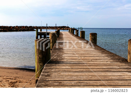 Long wooden pier on the sea. Landscape view. Long wooden pier on the sea. Landscape view. 116002823
