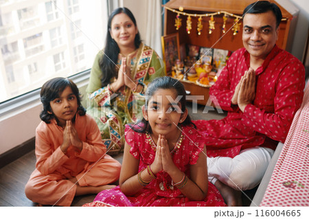 Indian Family Praying At Altar 116004665