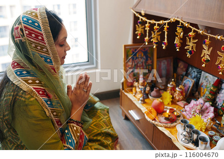 Indian Woman Praying At Altar 116004670
