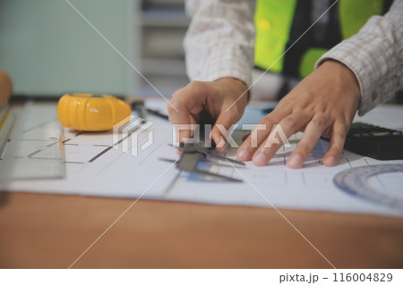 engineer people meeting working and pointing at a blueprint in office for discussing. Engineering tools and construction concept 116004829