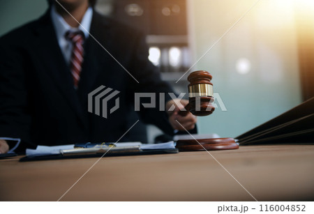 Judge gavel with Justice lawyers having team meeting at law firm background. Concepts of Law and Legal services. Judge gavel with Justice lawyers having team meeting at law firm background. Concepts of Law and Legal services. 116004852