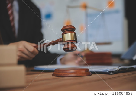 Judge gavel with Justice lawyers having team meeting at law firm background. Concepts of Law and Legal services. 116004853