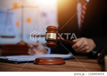 Judge gavel with Justice lawyers having team meeting at law firm background. Concepts of Law and Legal services. 116004854