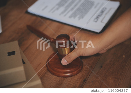 Judge gavel with Justice lawyers having team meeting at law firm background. Concepts of Law and Legal services. 116004857