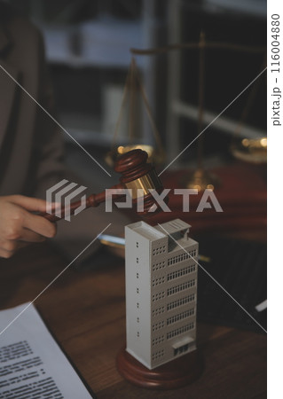 Real Estate Law, Home Insurance, property Tax, Auction and Bidding concepts. small toy house model with gavel justice hammer on desk in courthouse. Real Estate Law, Home Insurance, property Tax, Auction and Bidding concepts. small toy house model with gavel justice hammer on desk in courthouse. 116004880
