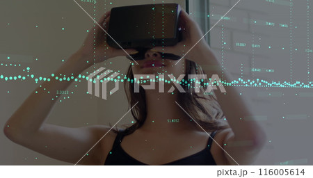 Image of financial data processing over caucasian woman using vr headset 116005614