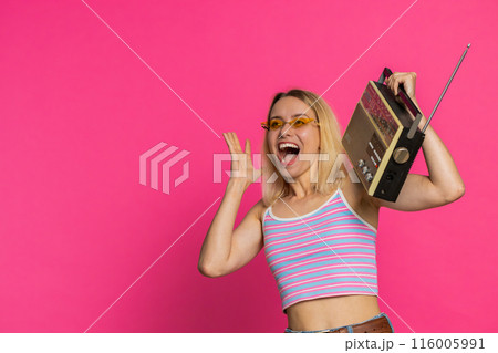 Happy woman listen music on retro tape record player, disco dancing, fan of vintage technologies 116005991