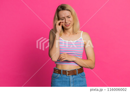 Upset disappointed woman wipes tears cries from despair, being sad because of unfair things 116006002