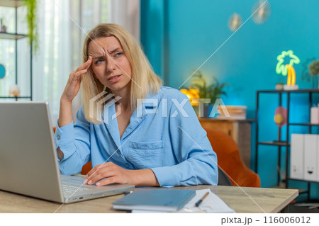 Tired ill businesswoman suffering from headache problem tension migraine stress at home office desk Tired ill businesswoman suffering from headache problem tension migraine stress at home office desk 116006012