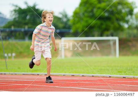 Child exercising. Kid running on stadium. 116006497