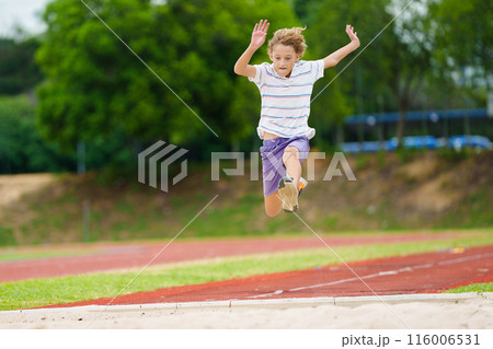 Kids long jump athletics training. Child jumping. 116006531