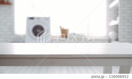 Folded white towels on countertop with laundry machine in background. AIG35. 116006952
