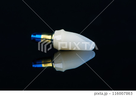 Individual abutment bonded to titanium fabric blue and yellow abutment on black background 116007863