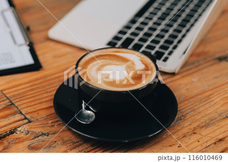 Closeup of coffee cup on table in empty corporate conference room before business meeting in office Closeup of coffee cup on table in empty corporate conference room before business meeting in office 116010469