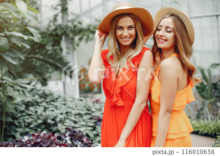 Beautiful girl in a red dress. Women in the greenhouse 116010638