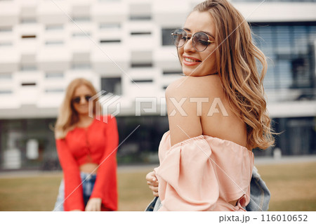 Beautiful girl in a red blouse. Women in a summer park. 116010652