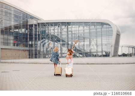 Girls at the airport. Friends with suitcasess Girls at the airport. Friends with suitcasess 116010668