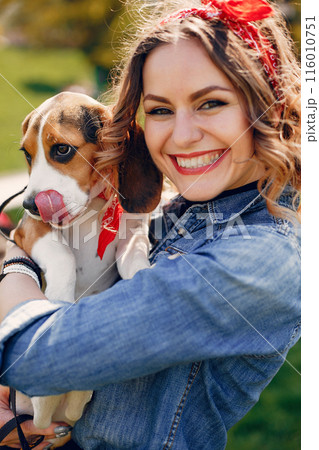 Beautiful girl in a blue blouse. Woman in a summer park. Lady with a dog Beautiful girl in a blue blouse. Woman in a summer park. Lady with a dog 116010751