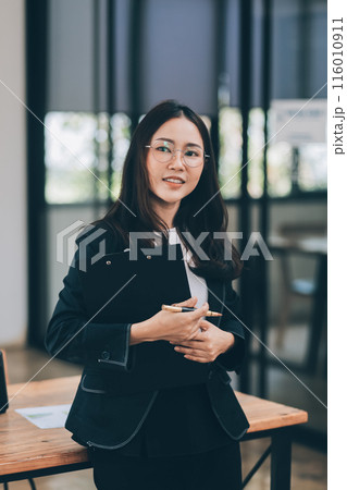 Happy young asian woman, using digital tablet isolated on office background 116010911