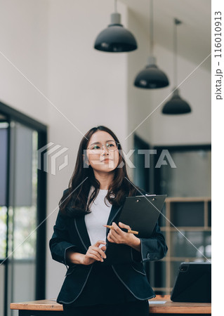 Happy young asian woman, using digital tablet isolated on office background 116010913