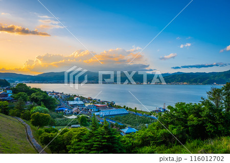 View of Suwa lake in Nagano, Japan in sunset time with city and mountain background. Landscape photo 116012702