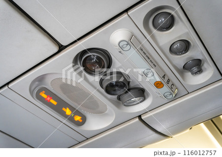 Air conditioner on the passenger seat with reading light and fasten your seat belt and no smoking symbols on the plane. Air conditioner on the passenger seat with reading light and fasten your seat belt and no smoking symbols on the plane. 116012757